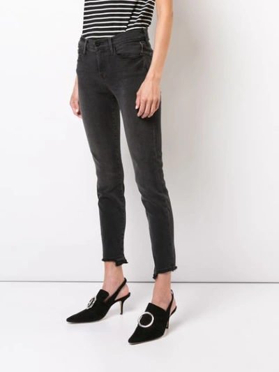 Shop Frame Cut Off Hem Jeans In Black