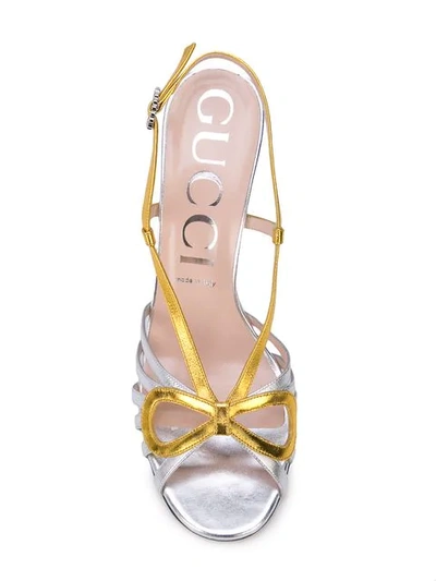 Shop Gucci Crossed Bow Sandals In Silver