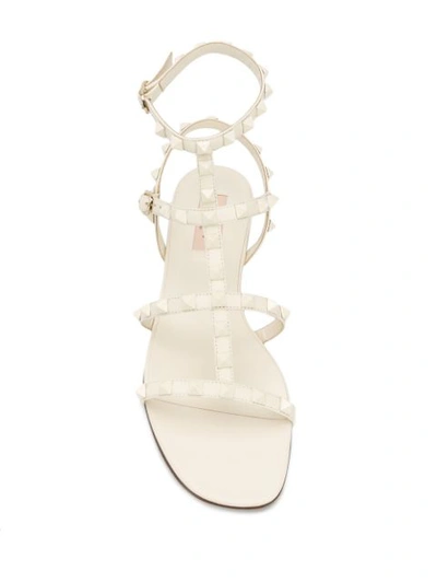 Shop Valentino Rockstud Caged Flat Sandals In Neutrals