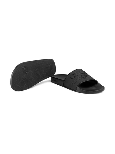 Shop Gucci Logo Rubber Slide Sandals In Black