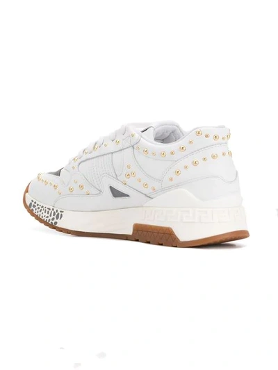 Shop Versace Studded Sneakers In White