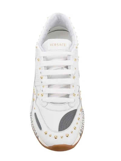 Shop Versace Studded Sneakers In White