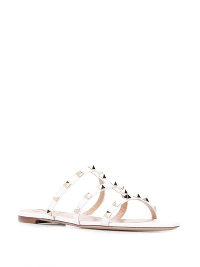 Shop Valentino Rockstud Flat Sandals In White