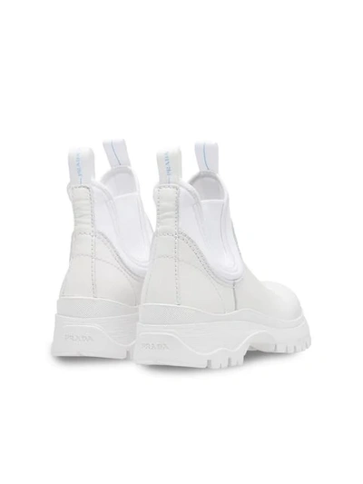 Shop Prada Round Toe Ankle Boots In White