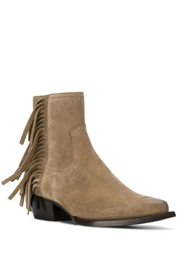 Shop Saint Laurent Lukas Fringed Boots In Brown