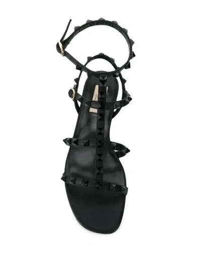 Shop Valentino Rockstud Flat Sandals In Black