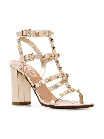 Shop Valentino Rockstud Block-heel Sandals In Gold