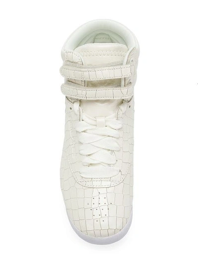 Shop Reebok Croco Embossed Sneakers In White