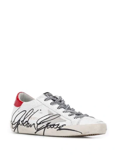 Shop Golden Goose Cracked Star Trainers In White