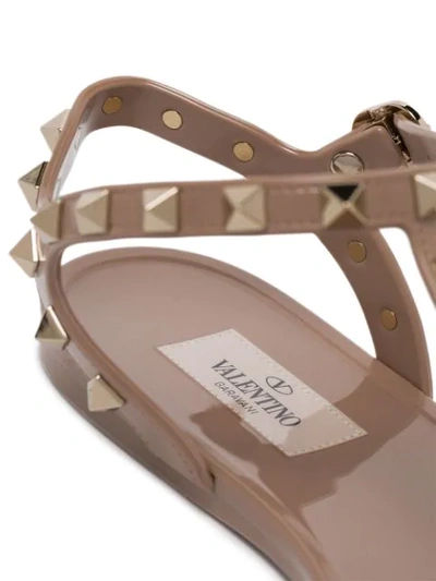 Shop Valentino Rockstud Jelly Flat Sandals In Neutrals