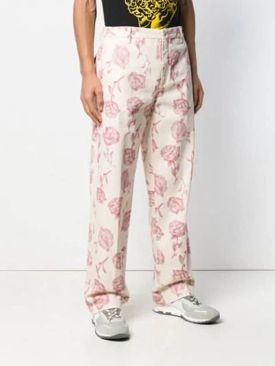 Shop Aries Rose Print Trousers In Neutrals