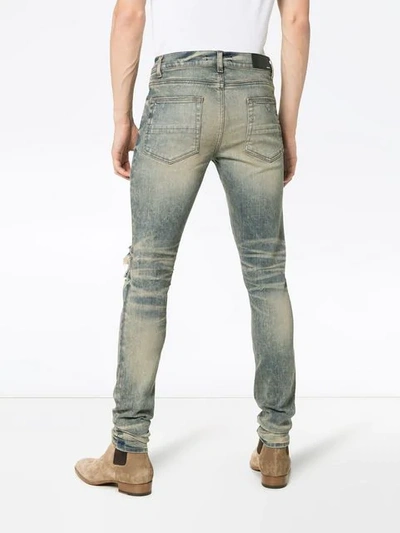 Shop Amiri Distressed Skinny Jeans In Blue