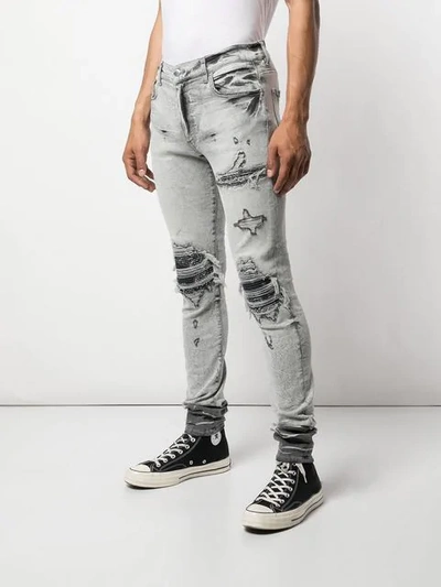 Shop Amiri Slim Distressed Jeans - White