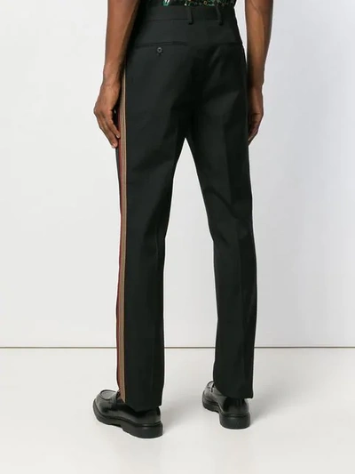 Shop Fendi Side Striped Trousers In Black