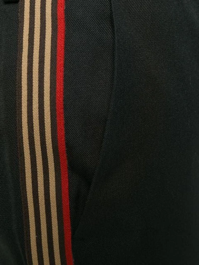 Shop Fendi Side Striped Trousers In Black