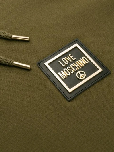 Shop Love Moschino Logo Plaque Hoodie In Green