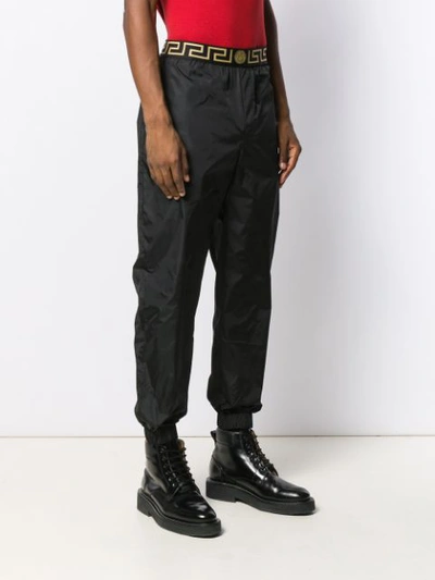 Shop Versace Elasticated Logo Track Trousers - Black