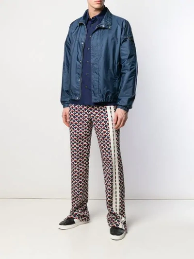 Shop Valentino Scale Print Trousers In Blue