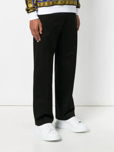 Shop Versace Flared Tailored Trousers In Black