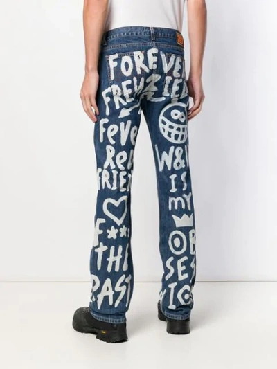 Shop Walter Van Beirendonck Vintage Written Paint Bootcut Jeans - Blue