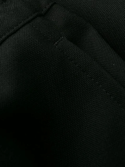 Shop Versace Elasticated Waist Loose Fit Trousers In Black