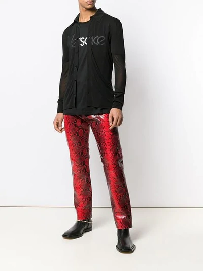 Shop Versace Snake Effect Trousers In Red