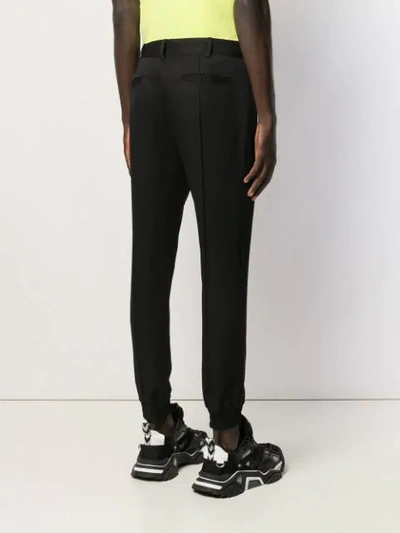 Shop Juunj Tapered Trousers In Black