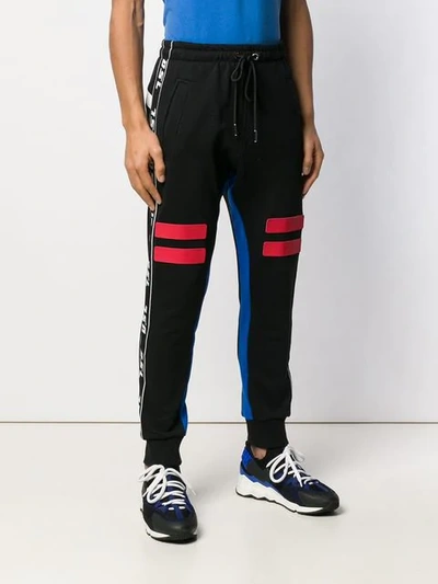 Shop Diesel Logo Tape Track Pants In Black