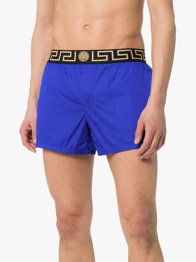 Shop Versace Logo Waist Swim Shorts In Blue