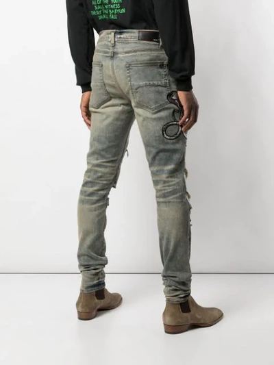 Shop Amiri Distressed-jeans Mit Kobra In Blue