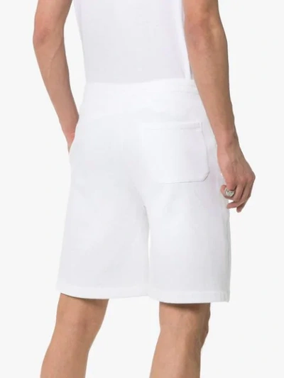 Shop Valentino Rockstud Track Shorts In White