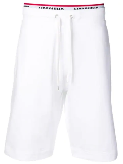 Shop Moschino Logo Stripe Track Pants In White