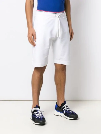 Shop Moschino Logo Stripe Track Pants In White