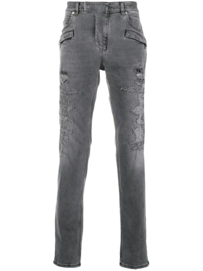 Shop Balmain Distressed 7 Pocket Skinny Jeans In Grey