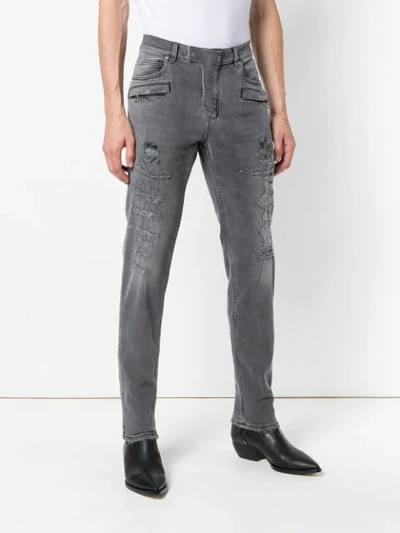 Shop Balmain Distressed 7 Pocket Skinny Jeans In Grey