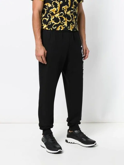 Shop Versace Logo Track Pants In Black