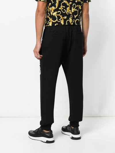 Shop Versace Logo Track Pants In Black