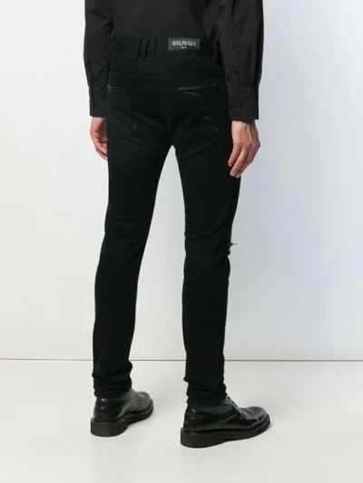 Shop Balmain Distressed Skinny Jeans In Black