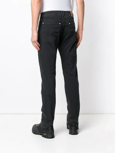 Shop Versace Straight Studded Trousers In Black