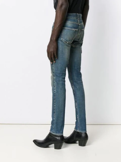 Shop Saint Laurent Ripped-detail Skinny Jeans In Blue