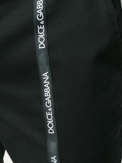 Shop Dolce & Gabbana Logo Strap Trousers In N0000 Nero.