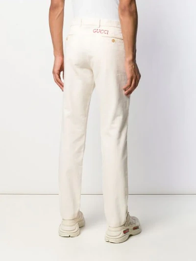 Shop Gucci Rear Embroidered Straight-leg Trousers In Neutrals