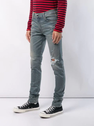 Shop Amiri Distressed Skinny Jeans - Blue