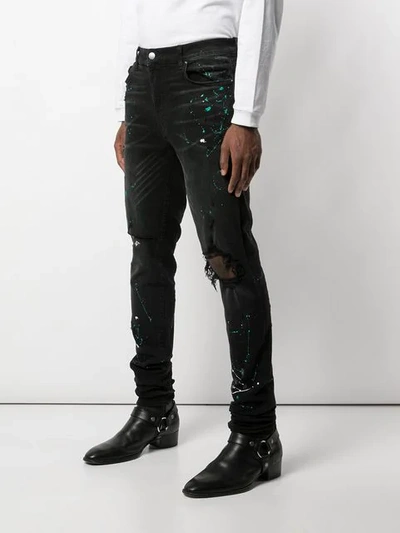 Shop Amiri Paint Splatter Slim-fit Jeans In Black ,green