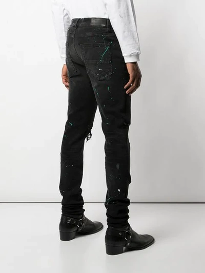 Shop Amiri Paint Splatter Slim-fit Jeans In Black ,green