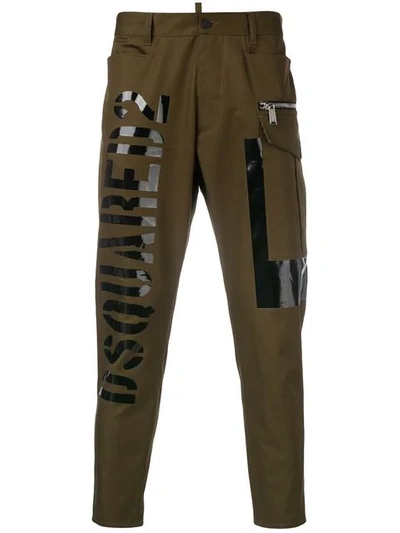 Shop Dsquared2 Tapered Logo Print Trousers In Green