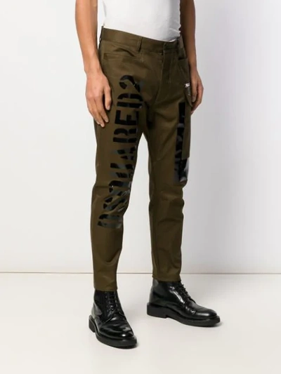 Shop Dsquared2 Tapered Logo Print Trousers In Green