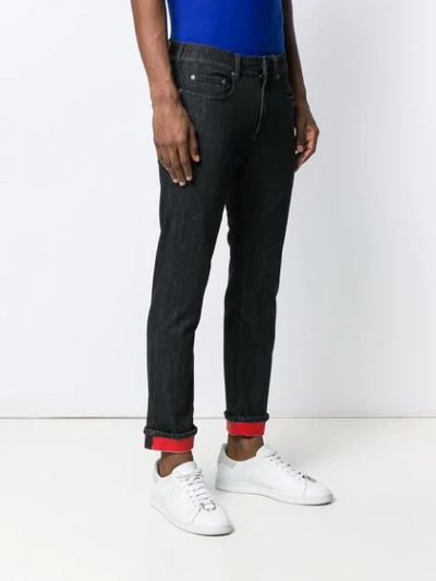 Shop Neil Barrett Contrast Hem Jeans In Black