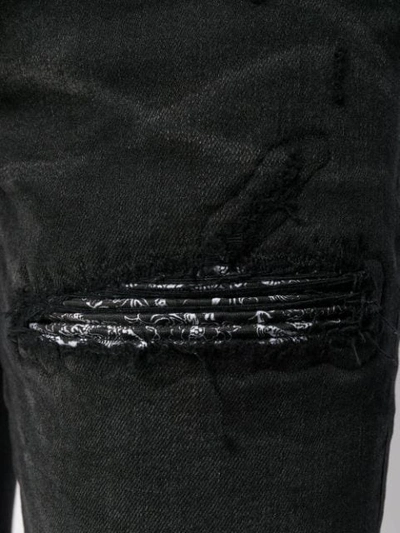 Shop Amiri Distressed Jeans - Black