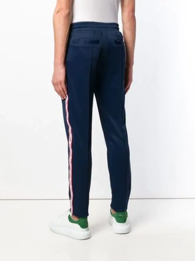 Shop Tommy Jeans Logo Tape Track Pants In Blue